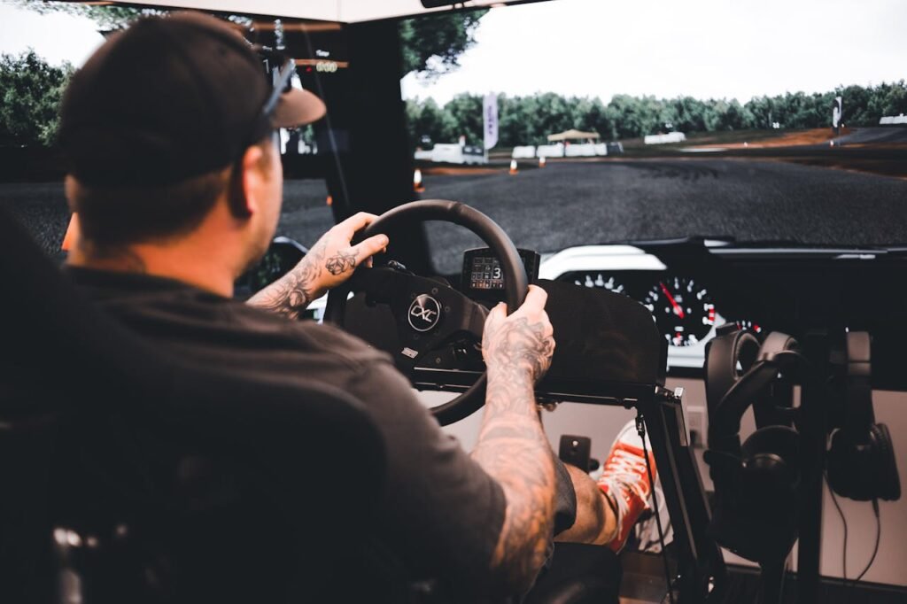 pexels photo 13251223 Focused gamer experiencing a detailed driving simulation setup indoors.